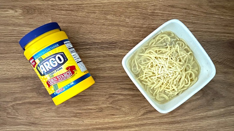 Container of cornstarch and cacio e pepe in white bowl