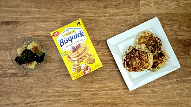 Bowl of roasted vegetables, box of Bisquik, pancakes on square white plate
