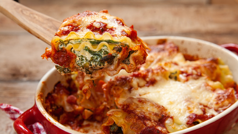 Rolled lasagna in red casserole dish