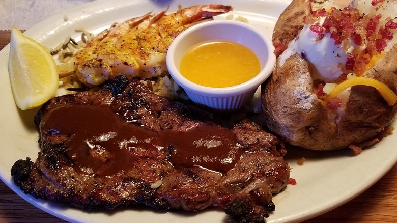 A plate of steak, shrimp, and baked potato from Logan's Roadhouse
