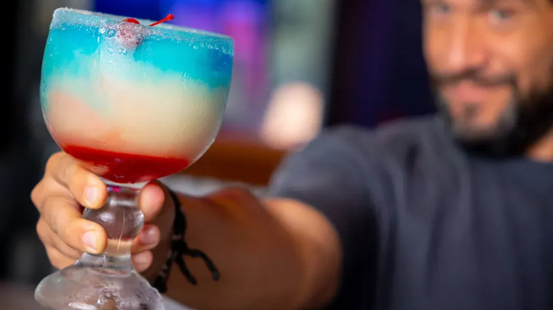 A Bubba's 33 bartender holds a frozen cocktail