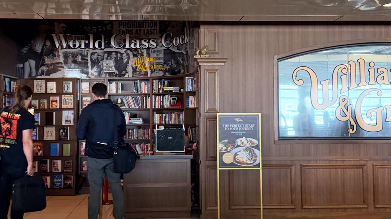 Travellers approach bookstore entrance to Williams and Graham Denver airport speakeasy