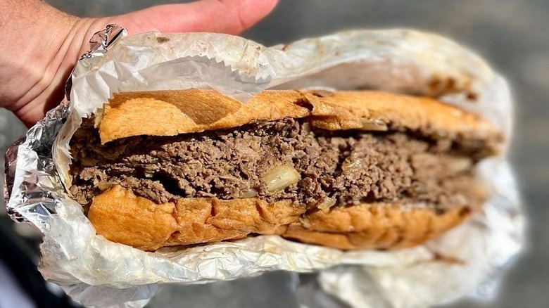 Cheesesteak in paper and tin foil