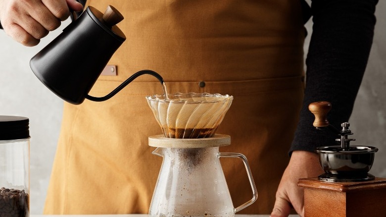 Person pouring water over coffee