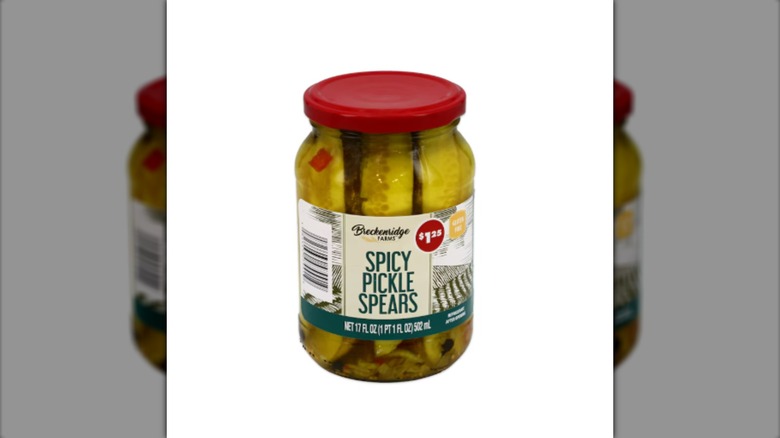 Jar of Breckenridge Farms Spicy Pickle Spears with a red lid against a white background.