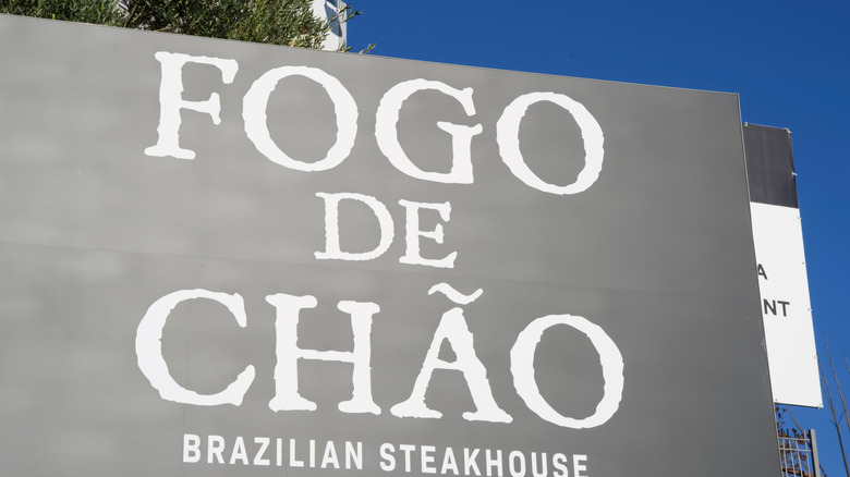 A Fogo de Chão sign against a blue sky