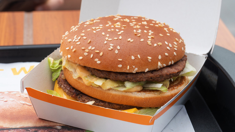 A McDonald's Big Mac in a white takeout box