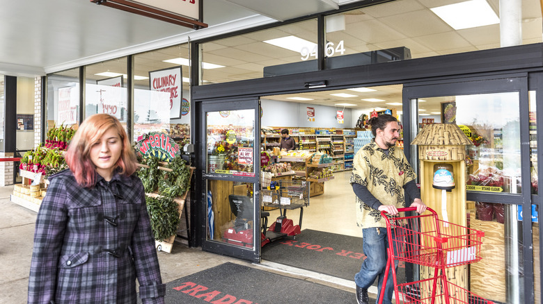 Customers walk past a Trader Joe's entrance