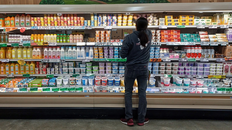A Trader Joe's employee restocks the dairy section