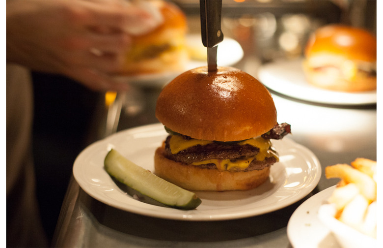 Blue Roof Bistro - Roasted Chili Steak Burger has a roasted chili sauce,flank  steak, beef patty, arugula, and melted Swiss in a potato bun served w/ a  side is the special of