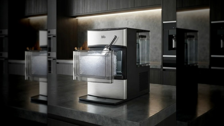 The Brio 740i Nugget Ice Maker on a countertop, ice drawer open with a scoop inside