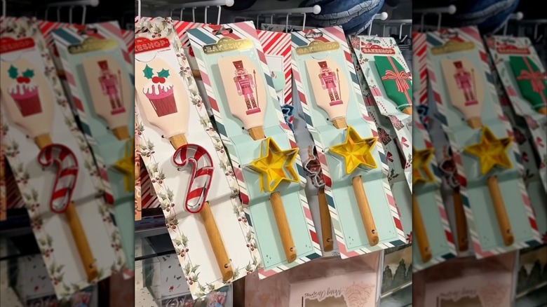 Christmas themed spatulas hanging from a rack