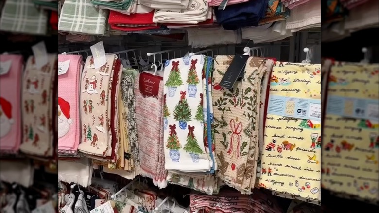Christmas themed tea towels hanging from a rack