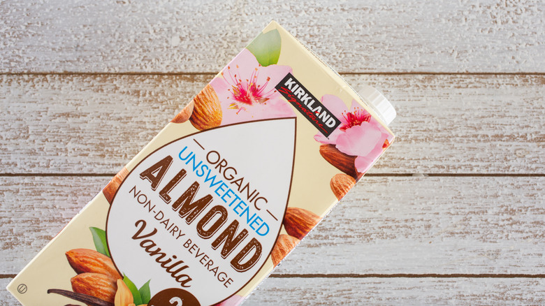 Almond milk carton on wooden background