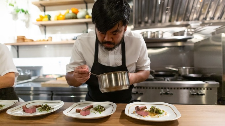 Chef of Archipelago Seattle serving food
