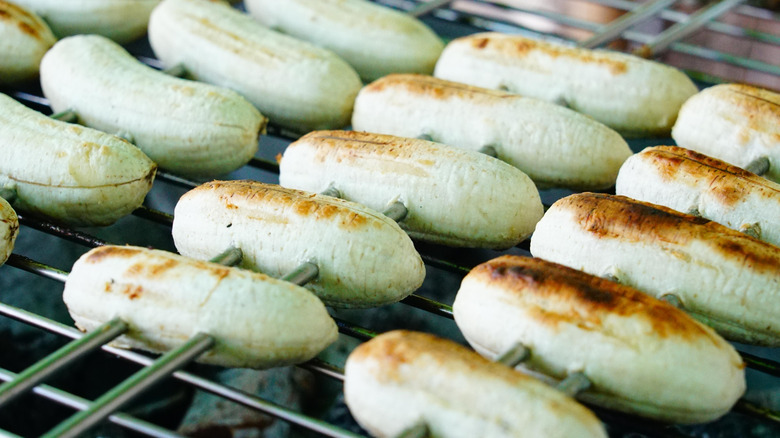Skewers of grilled bananas loaded up on a grill