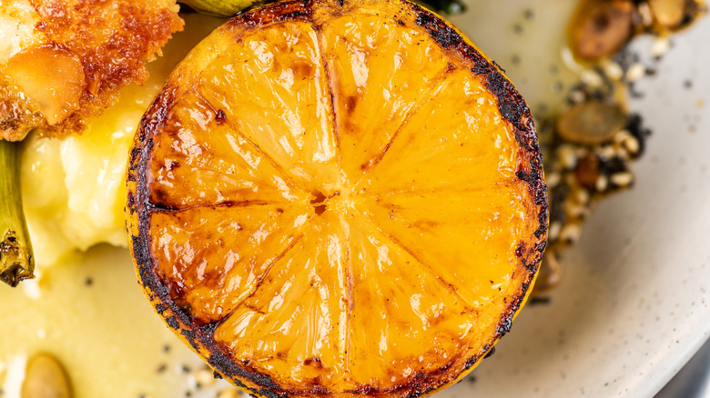 A closeup view of a grilled lemon half
