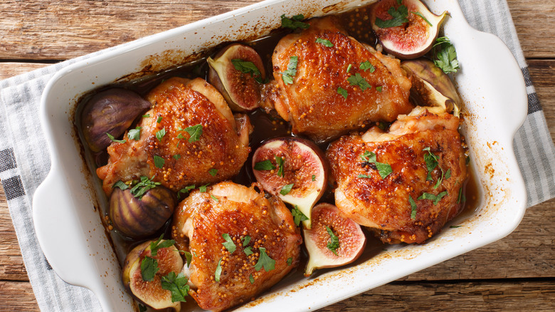 Chicken thighs in a baking dish with halved figs