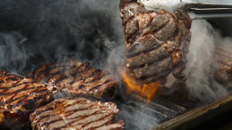 Steaks cooking on grill