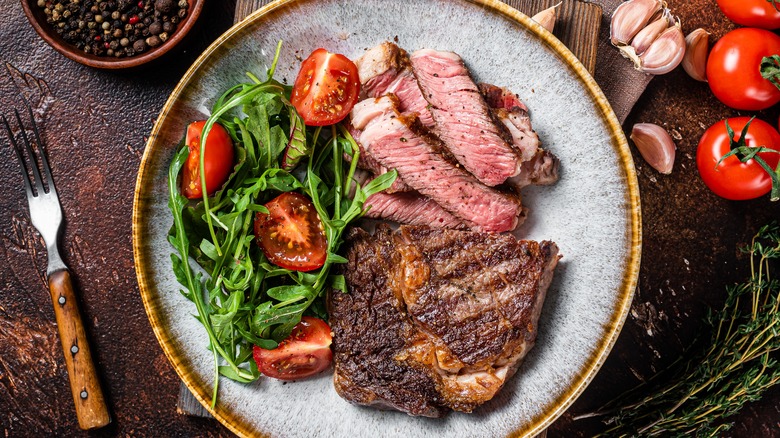 Grilled ribeye steak on plate