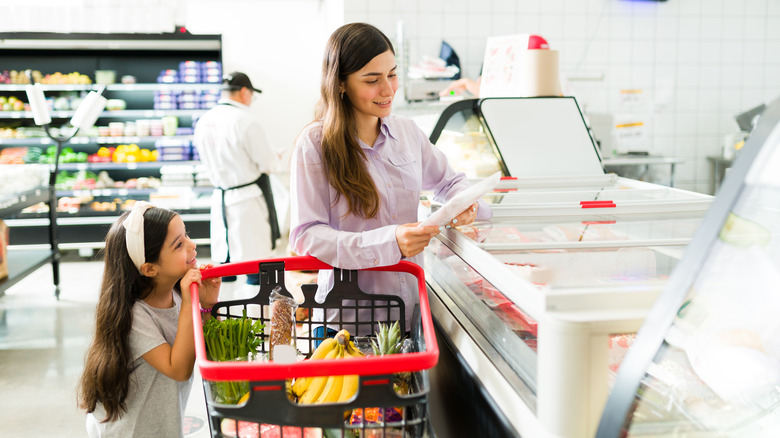 Mother and daughter grocery shopping