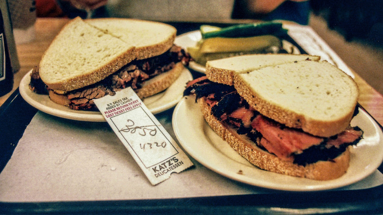 sandwiches and pickles on a tray at katz's