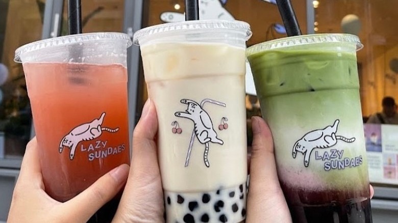 Hands holding Lazy Sundaes drinks