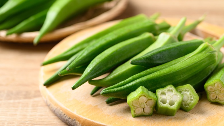 Fresh okra on wood board