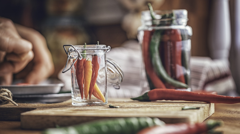 Fresh hot peppers in jars