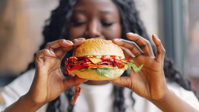 Woman holding burger