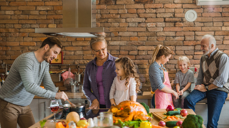 Man cooking with family visiting