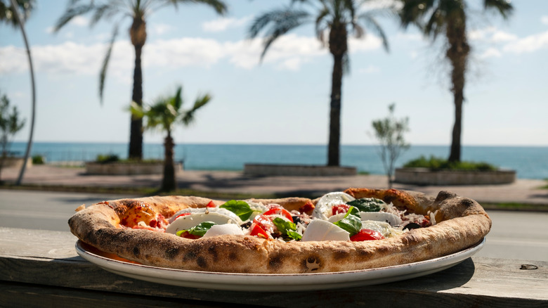 mozzarella basil pizza on beach