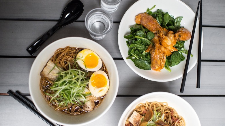 Ramen and appetizers on a table