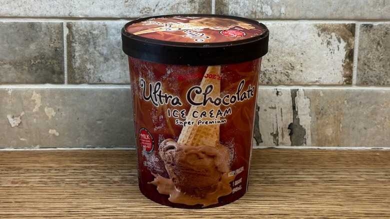 Trader Joe's Ultra Chocolate ice cream in a tub on a wooden counter