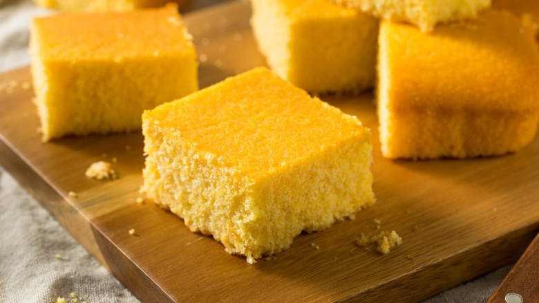 Squares of cornbread on a wooden board