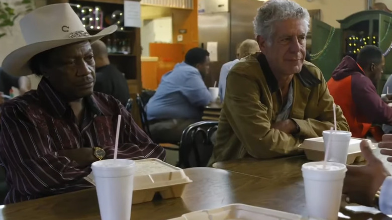 Anthony Bourdain chats with three men over lunch