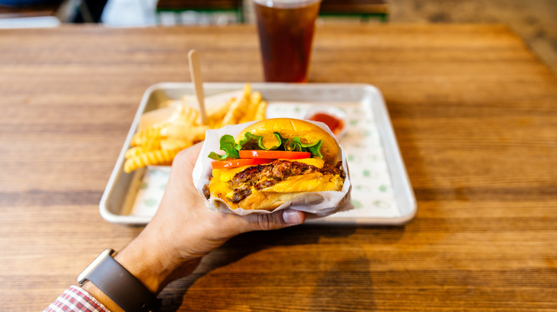person eating a burger at a fast food restaurant
