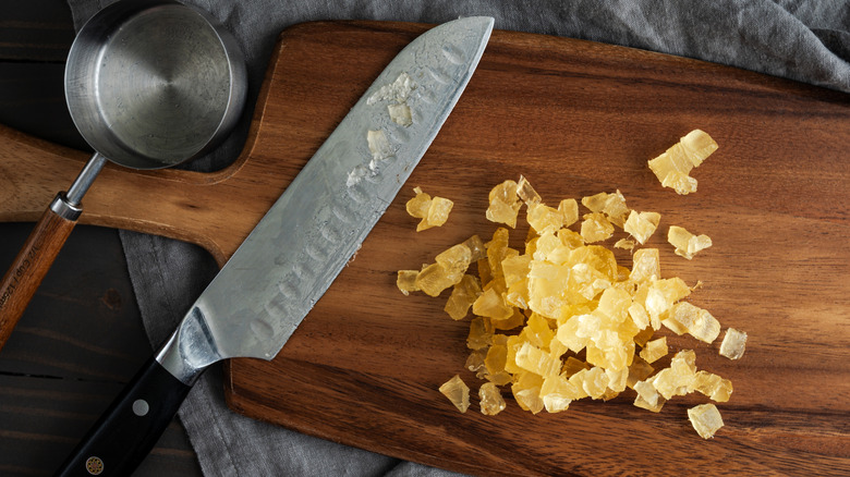 Santoku knife on a cutting board with candied pineapple