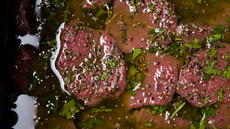 Meat in marinade of sauce and herbs