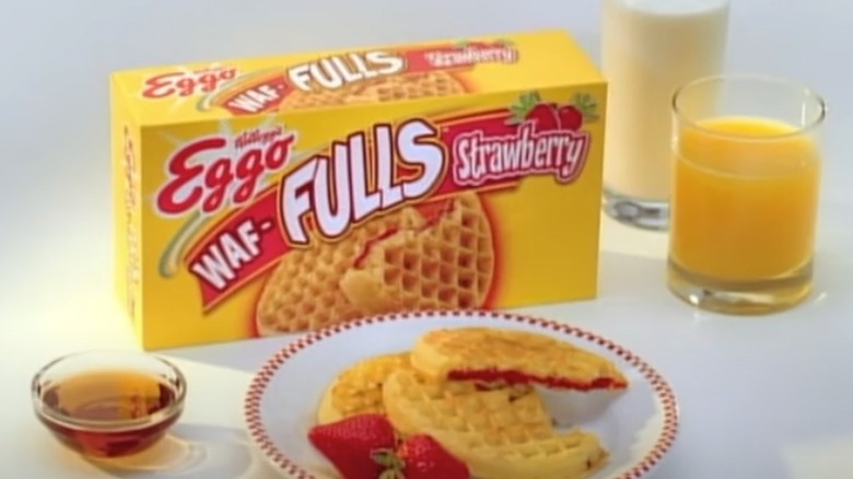 A box of strawberry Eggo Waf-Fulls sitting behind a plate of waffles