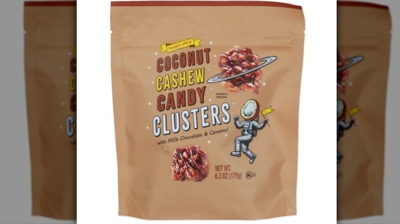 Coconut cashew candy clusters in a tan bag on white background