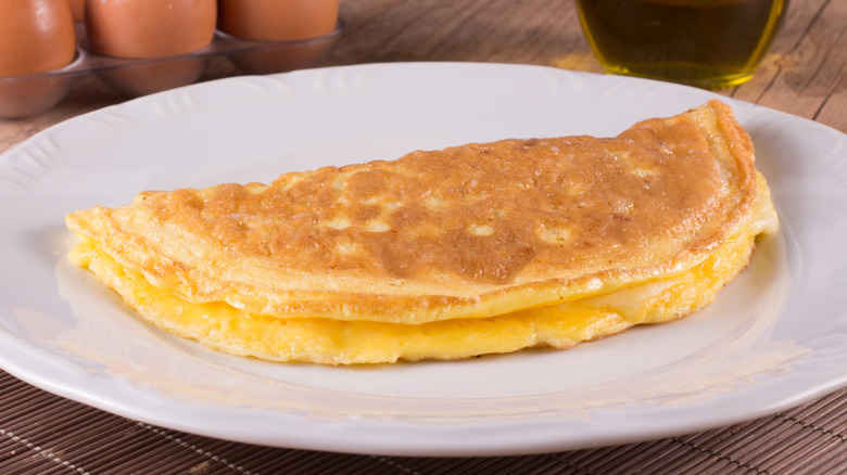 An omelet with cheese on a white plate