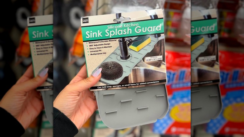 A hand holding a Silicone Kitchen Sink Splash Guard in-store