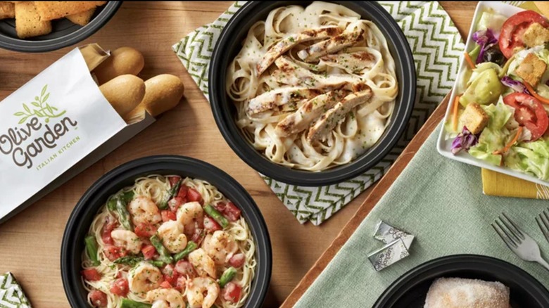 Olive Garden spread with breadsticks, pastas, and salad