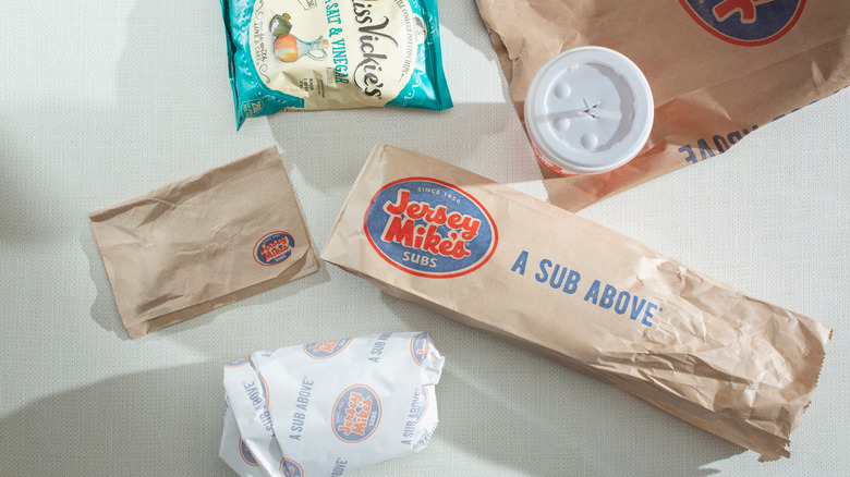 Wrapped Jersey Mike's sub with drink, chips, and napkin.