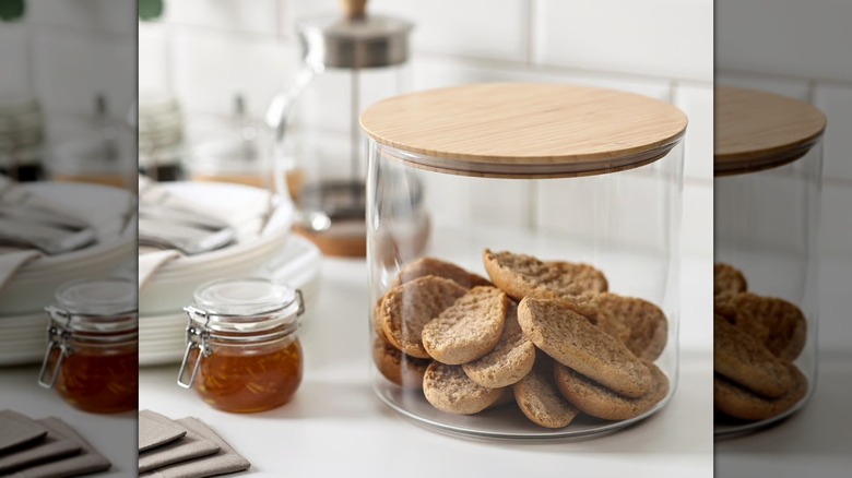 Glass jar with bamboo lid filled with bread on a kitchen countertop