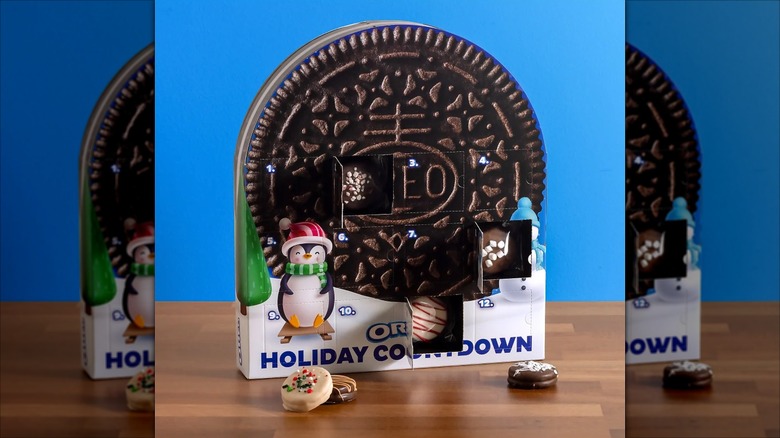 OREO Holiday Cookie Advent Calendar with a giant Oreo and a penguin against a sky blue background.
