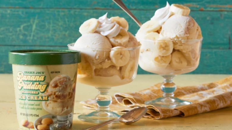 Tub of Trader Joes Banana Pudding Ice Cream with two banana ice cream sundaes in glasses in the back.