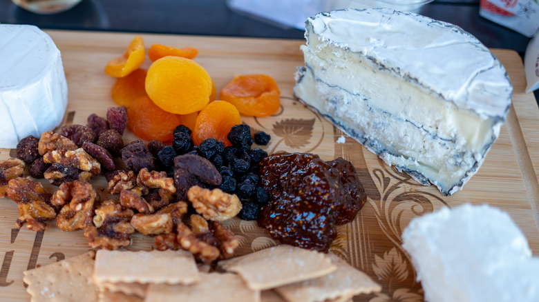 Cheese board with dried fruit and crackers