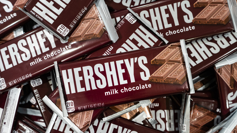 Many Hershey's Milk Chocolate Bars piled rogether